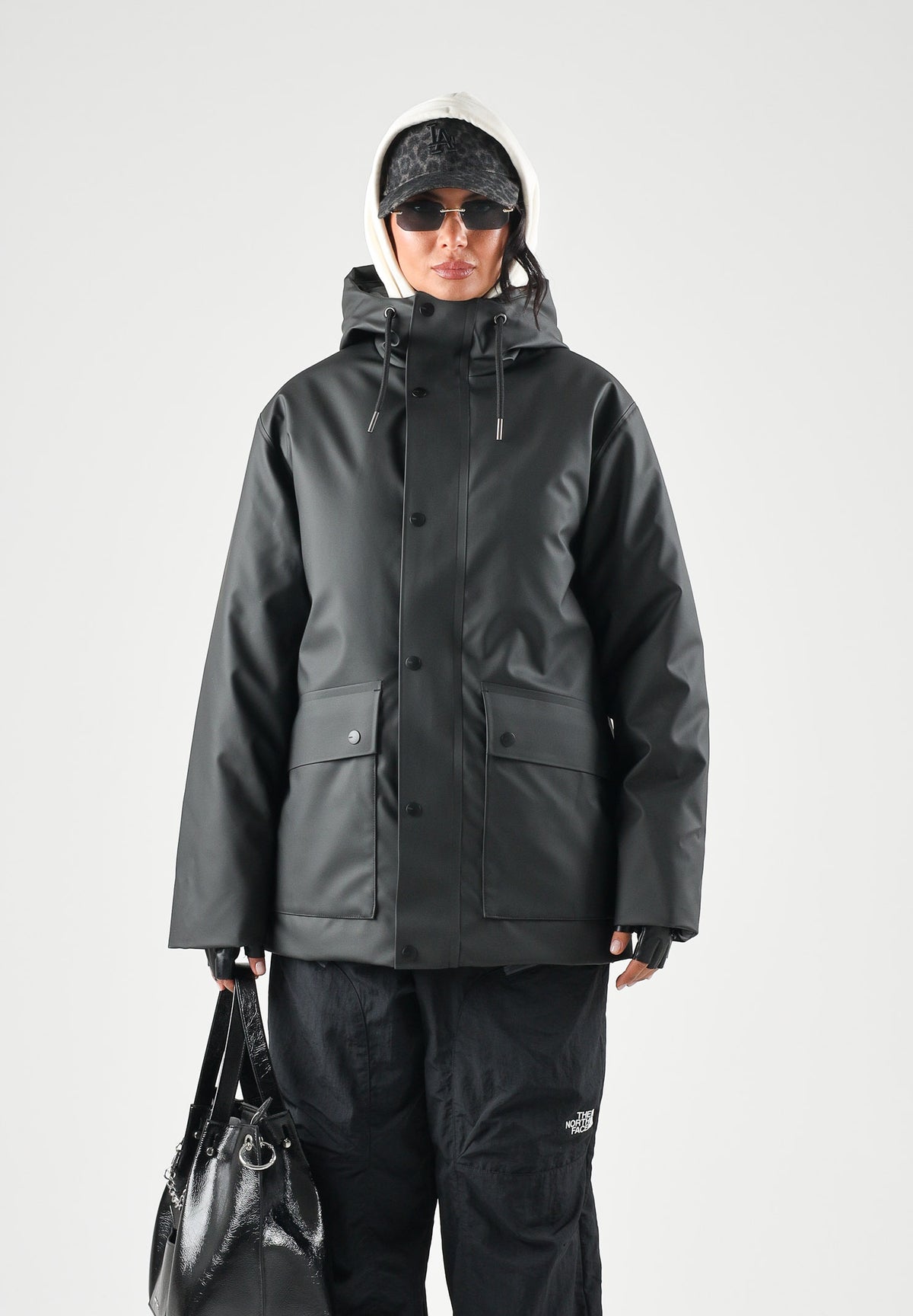 RAINS Parka nero per uomo e donna con cappuccio e visiera RA21450 BL RAINS