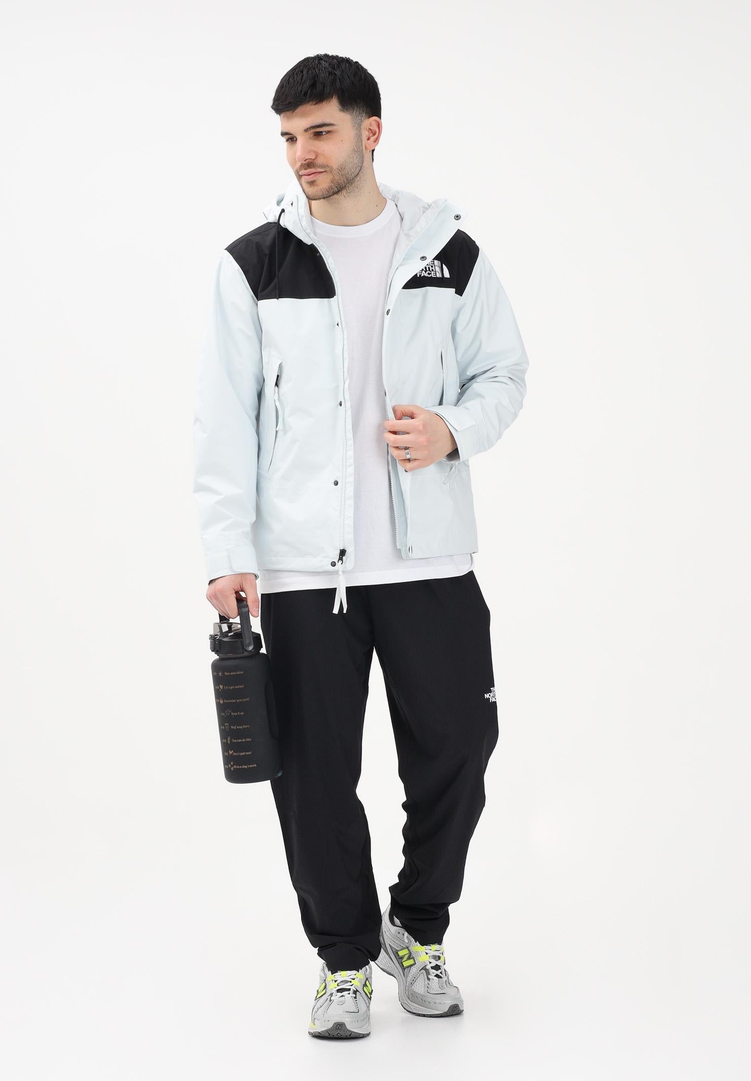 THE NORTH FACE Giacca a vento Reign On celeste e nera da uomo NF0A8B5GJL61 . THE NORTH FACE
