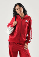 ADIDAS ORIGINALS Felpa con zip rossa per donna con colletto alto e iconiche tre strisce bianche. KS4675 . ADIDAS ORIGINALS 