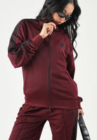 ADIDAS ORIGINALS Felpa con zip FIREBIRD maroon-bordeaux per donna con iconiche bande a contrasto. KS4678 . ADIDAS ORIGINALS 