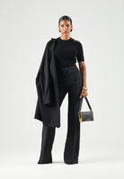 ELISABETTA FRANCHI Top in maglia nero da donna con applicazioni gioiello sulla spalla.<BR/> MK02S66E2 110 ELISABETTA FRANCHI 