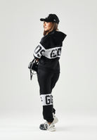 GCDS Pantaloni BAND LOGO TRACK PANTS nero per donna, ragzzi e bambini con fascia e maxi logo GCDS a contrasto. Z0UJQI588F004 999A GCDS 
