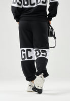 GCDS Pantaloni BAND LOGO TRACK PANTS nero per donna, ragzzi e bambini con fascia e maxi logo GCDS a contrasto. Z0UJQI588F004 999A GCDS 