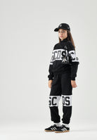GCDS Pantaloni BAND LOGO TRACK PANTS nero per donna, ragzzi e bambini con fascia e maxi logo GCDS a contrasto. Z0UJQI588F004 999A GCDS 