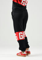 GCDS Pantaloni BAND LOGO TRACK PANTS nero/rosso per donna, ragazzi e bambini con maxi logo GCDS a contrasto. Z0UJQI588F004 999R GCDS 
