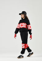 GCDS Pantaloni BAND LOGO TRACK PANTS nero/rosso per donna, ragazzi e bambini con maxi logo GCDS a contrasto. Z0UJQI588F004 999R GCDS 