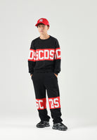 GCDS Pantaloni BAND LOGO TRACK PANTS nero/rosso per donna, ragazzi e bambini con maxi logo GCDS a contrasto. Z0UJQI588F004 999R GCDS 