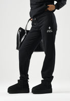 MARCELO BURLON COUNTY OF MILAN Pantaloni jogger neri per donna e ragazza con coulisse regolabile e logo frontale. F6CMJBFP051 110 MARCELO BURLON COUNTY OF MILAN 