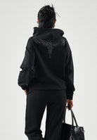 MARCELO BURLON COUNTY OF MILAN Felpa con cappuccio WINGS nera per donna e ragazza con  grafica effetto gioiello sul davanti. F6CMJGHS073 110 MARCELO BURLON COUNTY OF MILAN 