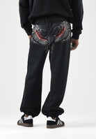 MARCELO BURLON COUNTY OF MILAN Pantaloni JOGGER CON LOGO neri da uomo con mini logo laterale F6CMMAFP014 110 MARCELO BURLON COUNTY OF MILAN 