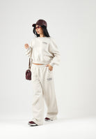 NEW BALANCE Pantaloni TRACKSIDE FLEECE bianco-panna da donna WB62983ALIT . NEW BALANCE 