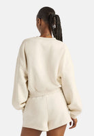 NEW BALANCE Felpa girocollo TRACKSIDE FLEECE CREW beige mélange  da donna con mini logo laterale WT62T7JOLIT . NEW BALANCE 