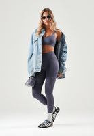 PUMA Top sportivo MID IMPACT grigio da donna con spalline incrociate sul retro e logo cat riflettente. 529062 35 PUMA 