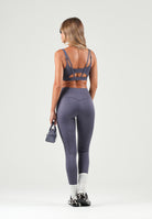 PUMA Top sportivo MID IMPACT grigio da donna con spalline incrociate sul retro e logo cat riflettente. 529062 35 PUMA 