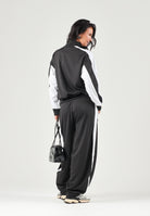 PUMA Felpa con zip DARE TO WOVEN T nero per donna con design bicolore, collo alto e tasca frontale zippata. 636632 01 PUMA 