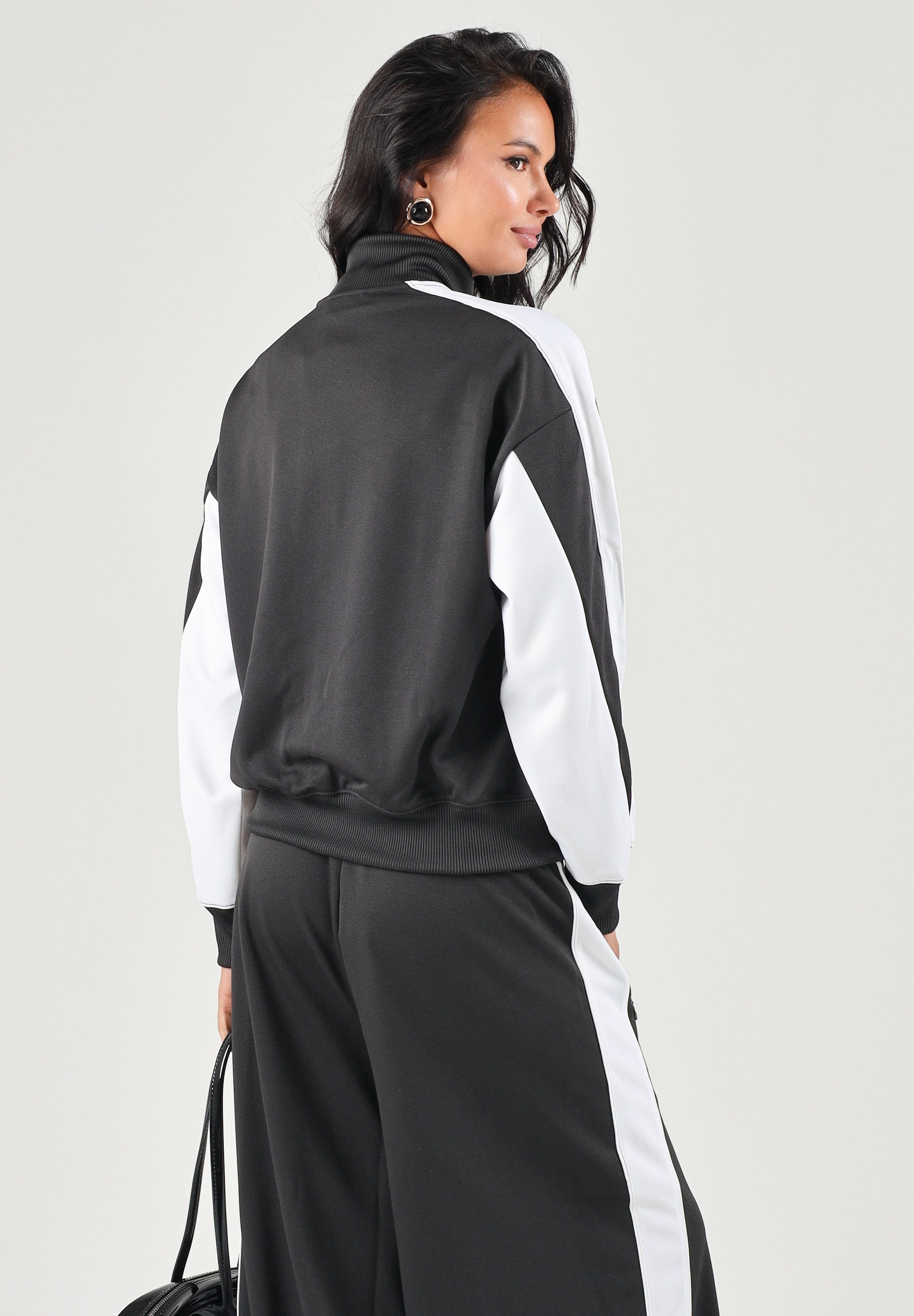 PUMA Felpa con zip DARE TO WOVEN T nero per donna con design bicolore, collo alto e tasca frontale zippata. 636632 01 PUMA 