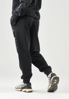 PUMA Pantalone DARE TO PRINTED  nero per donna con dettagli animalier sui fianchi e caviglie elasticizzate. 637612 01 PUMA 