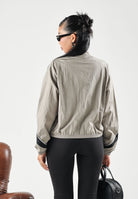 PUMA Giacca a vento DARE TO WOVEN TRACK  beige da donna con dettagli a contrasto e collo alto 694049 81 PUMA 