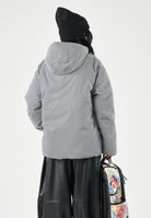 SPRAYGROUND Piumino grigio reversibile  per uomo e donna con cappuccio regolabile, chiusura frontale con zip SP942 . SPRAYGROUND 