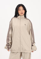 ADIDAS ORIGINALS Giacca a vento Firebird Adilenium beige da donna KD6297 . ADIDAS ORIGINALS 