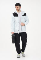 THE NORTH FACE Giacca a vento Reign On celeste e nera da uomo NF0A8B5GJL61 . THE NORTH FACE 