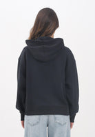 TOMMY JEANS Felpa con cappuccio nera da donna rifinita da logo DW0DW19414BDS  TOMMY JEANS 