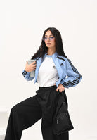 ADIDAS ORIGINALS Giacca a vento Teamgeist adicolor Cropped azzurra da donna JZ8277  ADIDAS ORIGINALS 