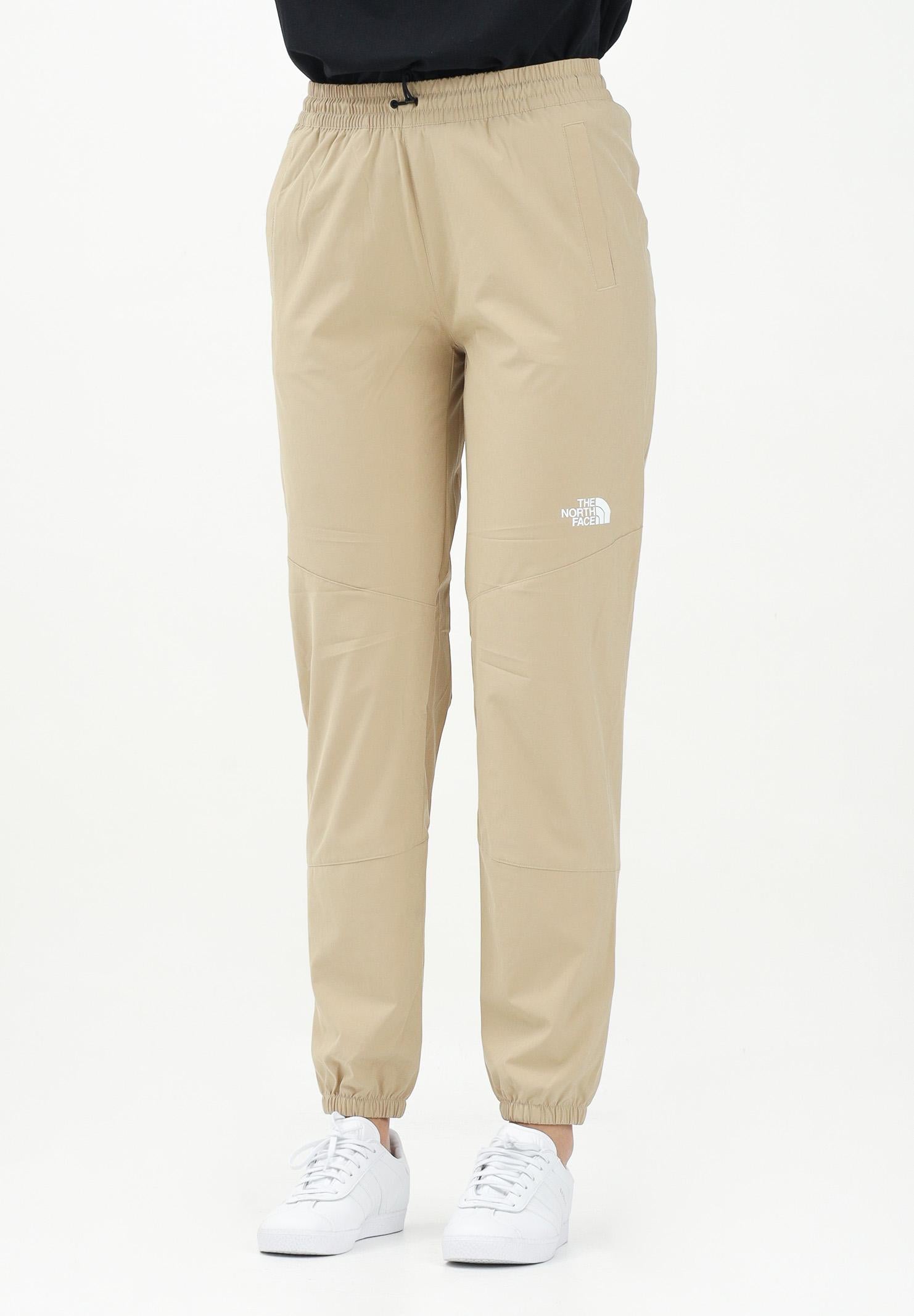 THE NORTH FACE Pantalone antivento Mountain Athletics beige da donna NF0A8BGPLK51 . THE NORTH FACE 