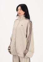 ADIDAS ORIGINALS Giacca a vento Firebird Adilenium beige da donna KD6297 . ADIDAS ORIGINALS 