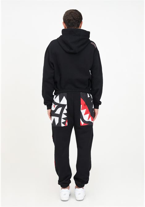 Black tracksuit trousers with pattern on the knees for men SPRAYGROUND | Pants | SP377.