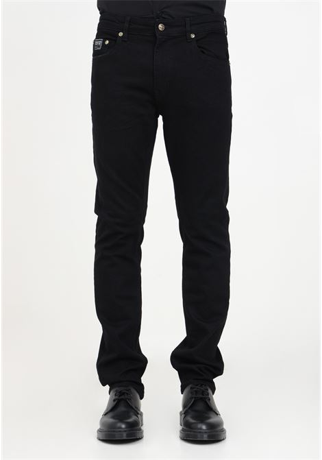 Jeans slim neri con applicazione da uomo VERSACE JEANS COUTURE | Pantaloni | 75GAB5S0CDW00909