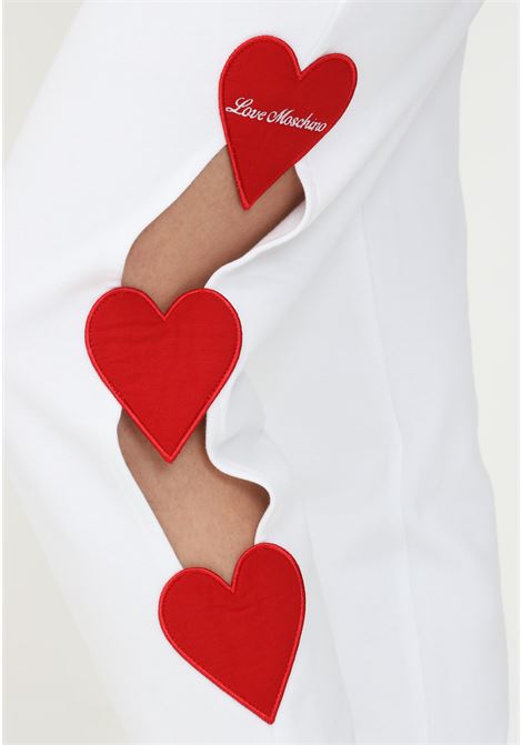 White women's trousers by love moschino with hearts and openings on the left side LOVE MOSCHINO | W158880M4266A00