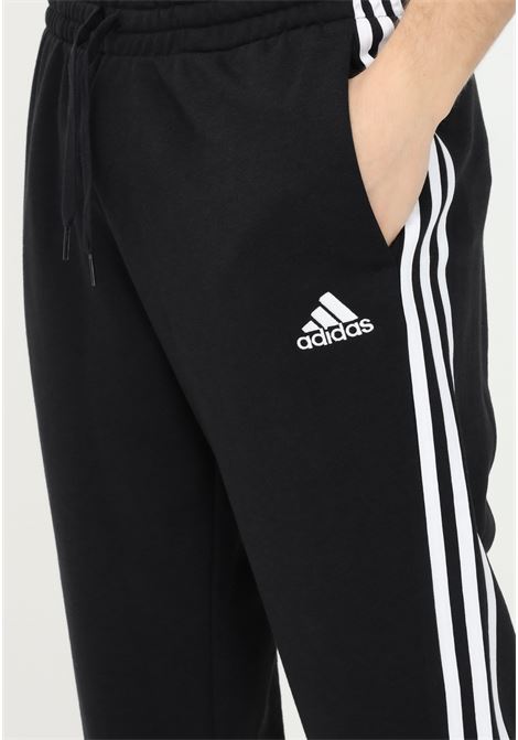 Black essentials french terry tapered cuff 3-stripes sport pants for men ADIDAS | GK8831.