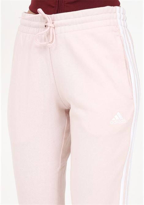 Pink sports pant for women in French terry essentials with 3 stripes ADIDAS | IC9924.