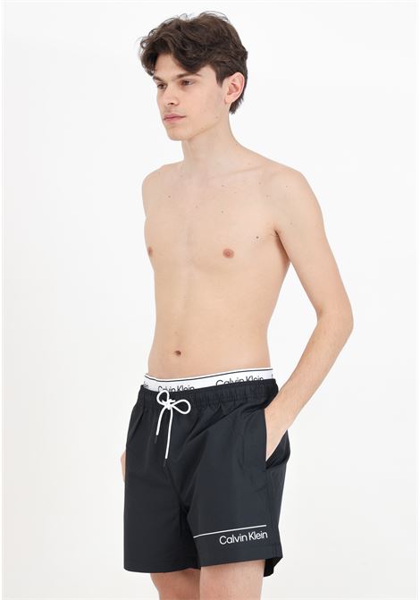 Black men's swim shorts with logo print and logoed elastic waistband CALVIN KLEIN | KM0KM00957BEH