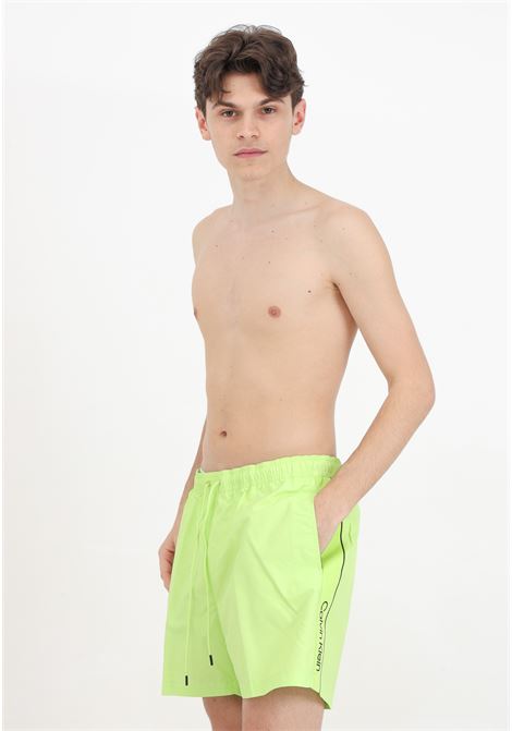 Men's neon swim shorts with logoed side bands CALVIN KLEIN | Beachwear | KM0KM00958LKQ