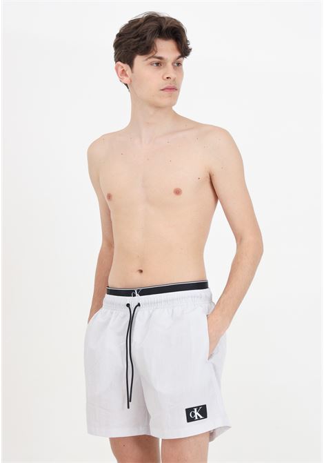 Gray men's swim shorts with logo patch and elasticated slip model CALVIN KLEIN | KM0KM00981CHZ
