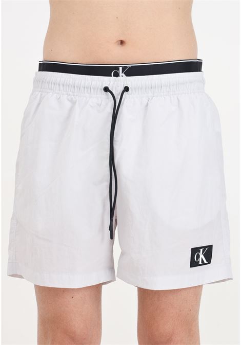 Gray men's swim shorts with logo patch and elasticated slip model CALVIN KLEIN | Beachwear | KM0KM00981CHZ