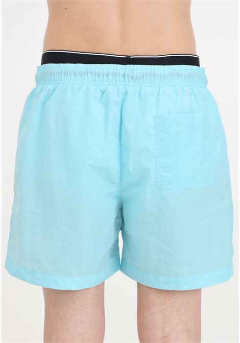 Turquoise men's swim shorts with logo patch and elasticated slip model CALVIN KLEIN | Beachwear | KM0KM00981CSY