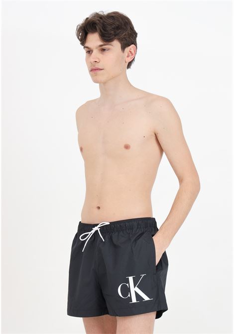 Black men's swim shorts with CK monogram print CALVIN KLEIN | Beachwear | KM0KM01015BEH