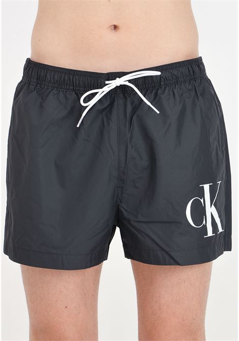 Black men's swim shorts with CK monogram print CALVIN KLEIN | Beachwear | KM0KM01015BEH