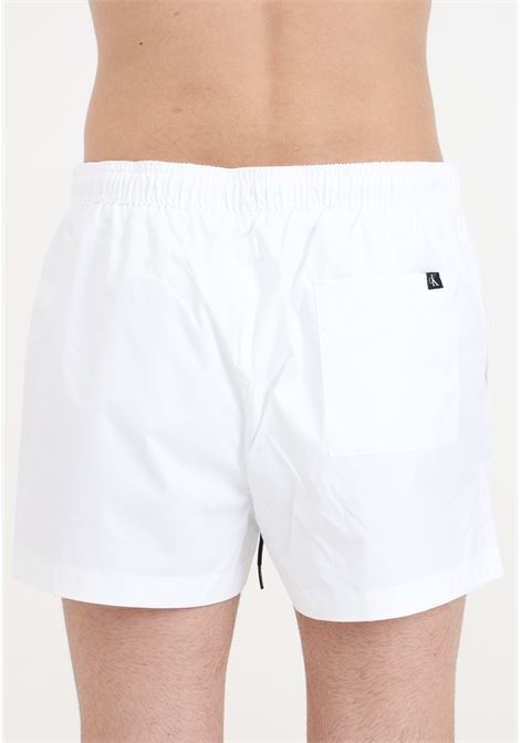White men's swim shorts with CK monogram print CALVIN KLEIN | Beachwear | KM0KM01015YCD