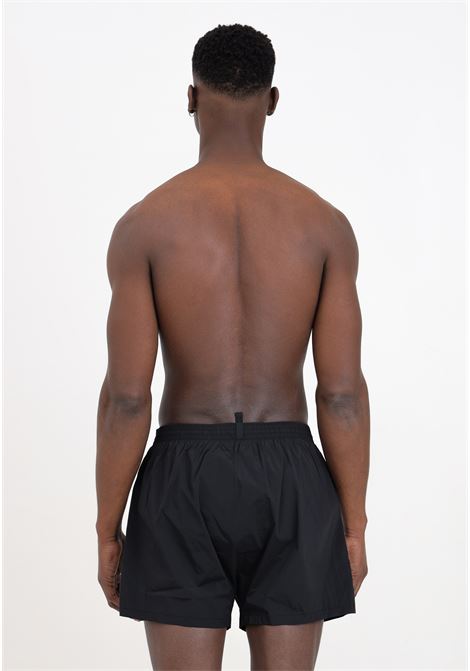 Shorts mare da uomo neri stampa logo con schizzo di vernice in bianco DSQUARED2 | Beachwear | D7B645420010