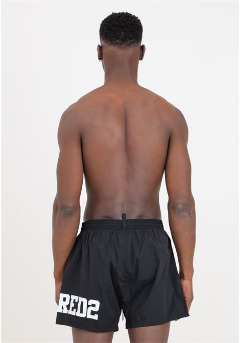 Shorts mare neri da uomo con stampa logo laterale in bianco DSQUARED2 | Beachwear | D7B8P5440010