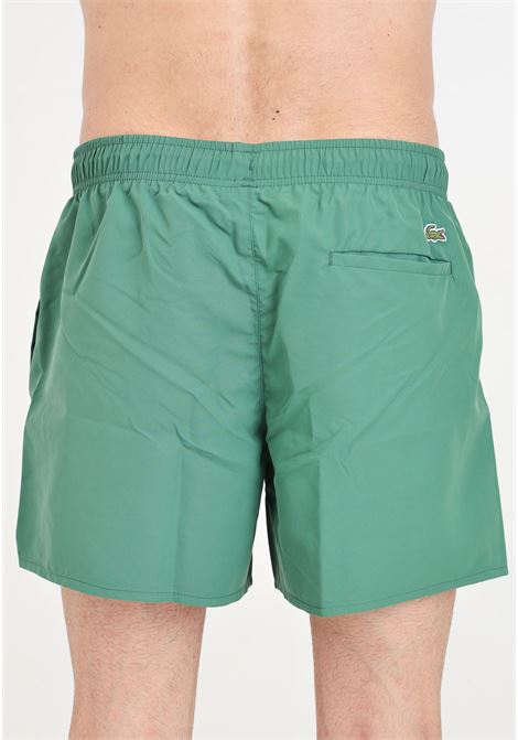 Shorts mare verde con stampa logo sul davanti e patch logo LACOSTE | Beachwear | MH6912132