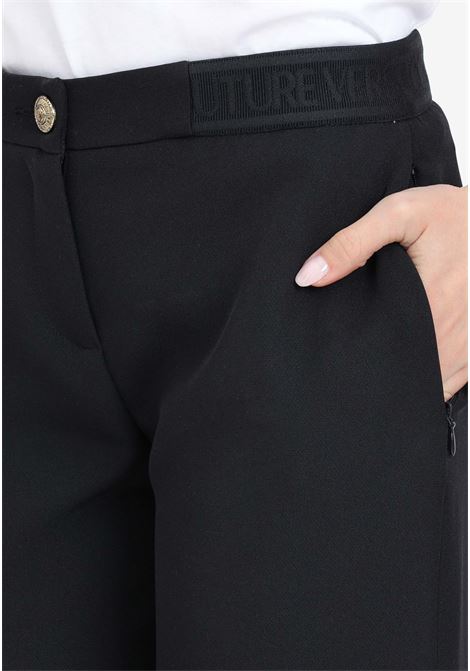 Black women's trousers with logo elastic VERSACE JEANS COUTURE | Pants | 76HAA112N0103899